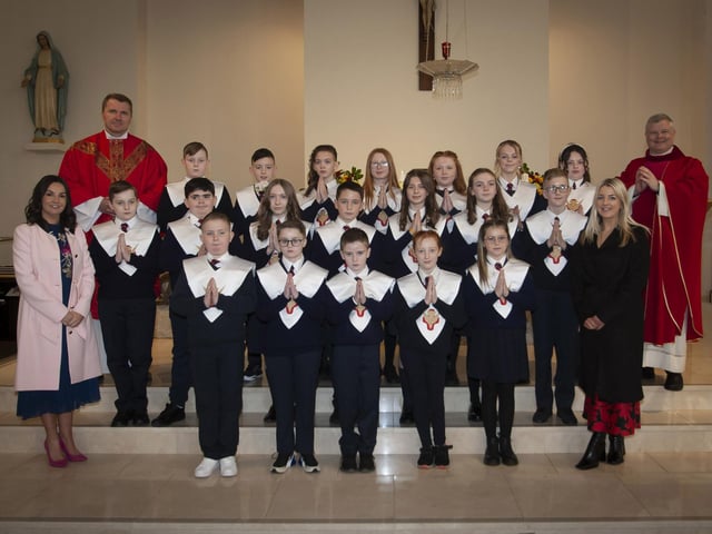Children from Holy Child PS, Creggan who received the Sacrament of Confirmation from Fr. Daniel McFaul at St. Mary’s Church, on Friday afternoon last. Included from left are Mrs. Pat Concannon, Principal, Fr. Ignacy, and on right, Miss Colleen McBrearty, teacher. (Photo: Jim McCafferty Photography)