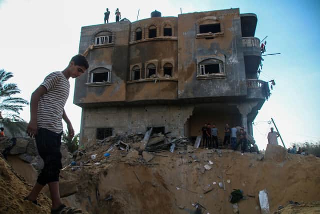 KHAN YOUNIS, GAZA - OCTOBER 16: Palestinian citizens inspect their home destroyed during Israeli raids in the southern Gaza Strip on October 16, 2023 in Khan Yunis, Gaza. Gazans are evacuating to the south following warnings to do so from the Israeli government, ahead of an expected Israeli ground offensive. Israel has sealed off Gaza and launched sustained retaliatory air strikes, which have killed at least 2,500 people with more than 400,000 displaced, after a large-scale attack by Hamas. On October 7, the Palestinian militant group Hamas launched a surprise attack on Israel from Gaza by land, sea, and air, killing over 1,300 people and wounding around 2,800. Israeli soldiers and civilians have also been taken hostage by Hamas and moved into Gaza. The attack prompted a declaration of war by Israeli Prime Minister Benjamin Netanyahu and the announcement of an emergency wartime government. (Photo by Ahmad Hasaballah/Getty Images)