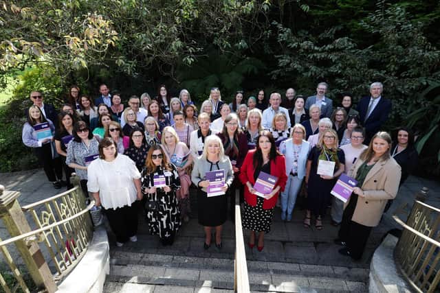 The First and Deputy First Ministers launching the new strategy with women from across the north.