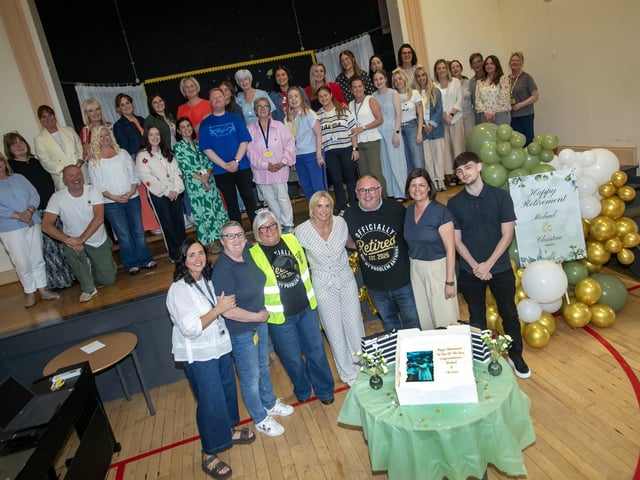 Model Primary School retirees - classroom assistant Mrs. Christine Slevin and vice principal, Mr. Michael Bradley, pictured with staff and families on the occasion of their retirement on Monday. (Photos: Jim McCafferty Photography)