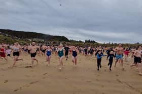 Some of the swimmers who braved the waters at Culdaff beach on New Year's Day 2024 for various charities.