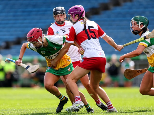 Offaly's Caoimhe O'Donovan is tackled by Orlaith Hull of Derry during the Very Camogie League Division 2A Final in Thurles. (Photo: INPHO/Ben Brady)
