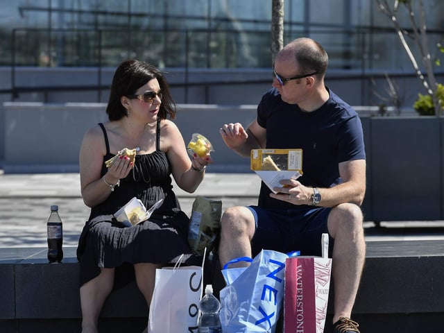 People enjoy the warm sunshine in Ebrington Square. Photo: George Sweeney