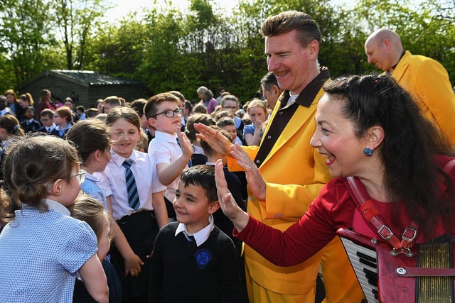 Pupils greet members of the Jive Aces at Rosemount Primary School on Thursday morning. Photo: George Sweeney