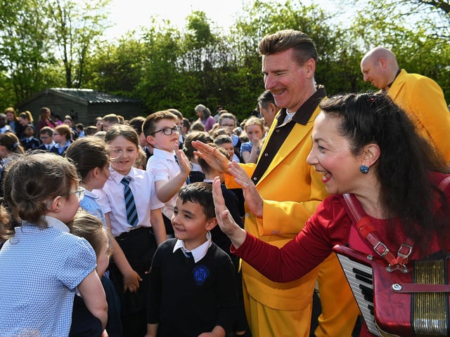 Pupils greet members of the Jive Aces at Rosemount Primary School on Thursday morning. Photo: George Sweeney