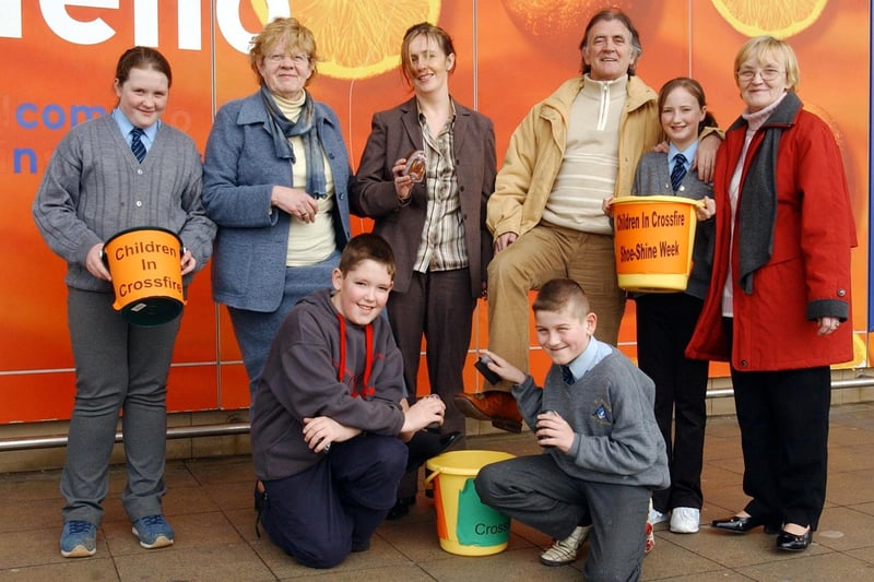 Radio Ulster presenter, Gerry Anderson, puts his best foot forward to support the Children in Crossfire annual Shoeshine by pupils of St Anne's Primary School. At front are Gary Doherty and Kieran McGilloway. Back from left are Nadine McGilloway, Mary Kelly, volunteer, Bridin Flanagan, development officer, Michaela Cusack and Alice Havord, volunteer.