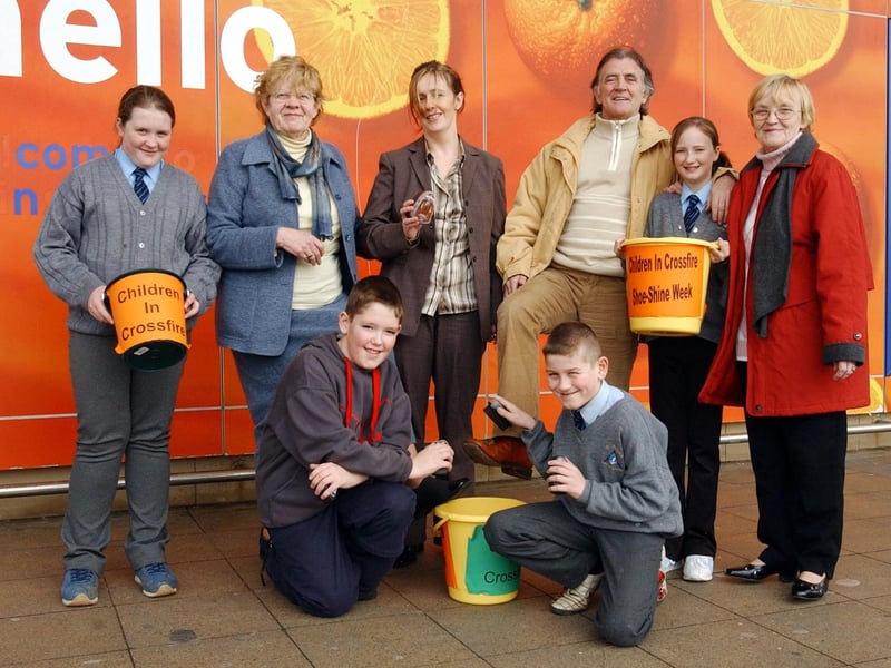 Radio Ulster presenter, Gerry Anderson, puts his best foot forward to support the Children in Crossfire annual Shoeshine by pupils of St Anne's Primary School. At front are Gary Doherty and Kieran McGilloway. Back from left are Nadine McGilloway, Mary Kelly, volunteer, Bridin Flanagan, development officer, Michaela Cusack and Alice Havord, volunteer.