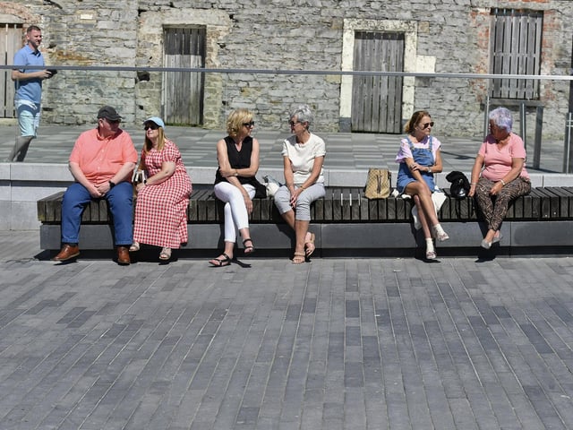 People enjoy the warm sunshine in Ebrington Square. Photo: George Sweeney