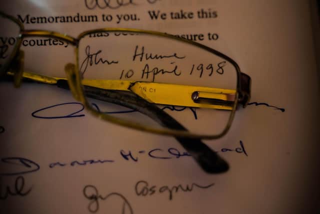 John Hume's glasses and signature on a signed copy of the Good Friday Agreement.