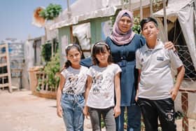 Mental Health Lifeline: Hana (42) with her children Samer (13), Salma (10) and Roula (8). The family have been living in a Syrian refugee camp in Lebanon after they were forced to flee from their home. Credit: Hazar Al Zahr.