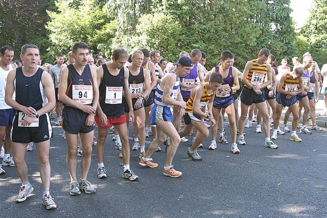 Runners set their watches at the start of the Waterside Half-Marathon . (1609T32).:.