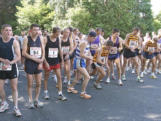 Runners set their watches at the start of the Waterside Half-Marathon . (1609T32).:.