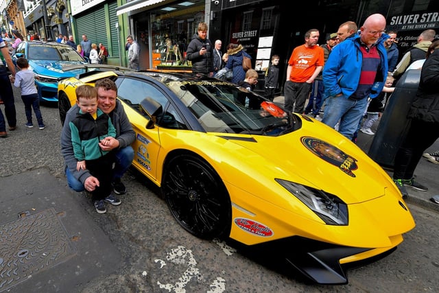 Caolan and his dad Aaron pictured beside one of the super cars that took part in the Bear Run from Derry’s Shipquay Street to Donegal and Inishowen, on Saturday morning, raising funds for Bumbleance, the Children’s Ambulance Service. Photo: George Sweeney.  DER2317GS – 119