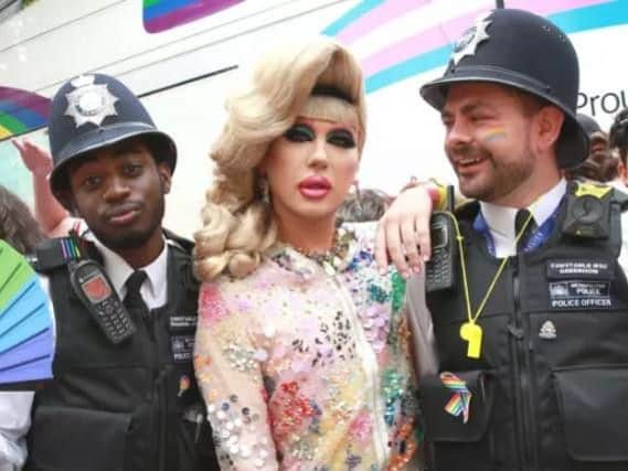 Police with cross-dresser Jodie Harsh at London gay pride on Saturday.
