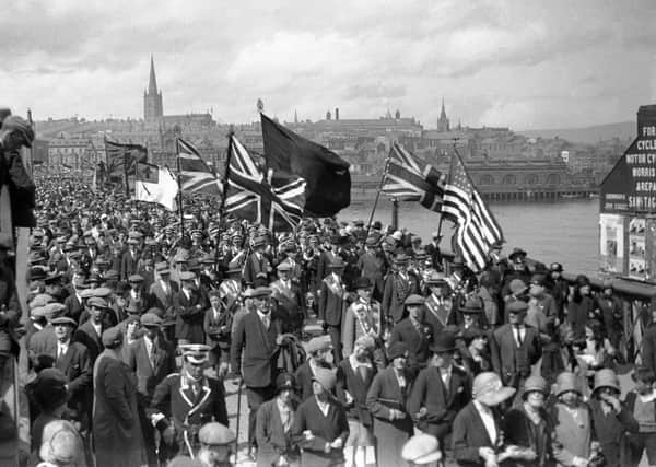 A loyalist parade makes its way across Craigavon Bridge.