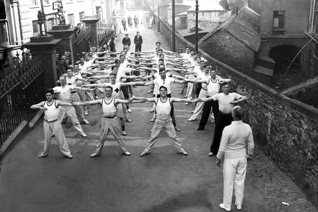 A group of men take part in a fitness class outside the YMCA premises which were located on East Wall.