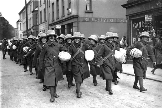 Soldiers, wearing helmets that look suited to hotter climes, march along Limavady Road - possibly to the nearby train station.