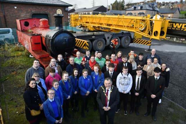 The Mayor, Councillor Maoliosa McHugh pictured with members of Destined and pupils and staff from St. Mary's College and St. Joseph's Boys' School, when he visited the Destined centre at the Foyle Valley Railway to see an old railway steam engine loaded on to a lorry to be taken to the Railway Preservation Society at Whitehead where it will be restored, the engine will be returned in six months time to be put on display at the front of the building. The students are taking part in a project to examine the history of the engine and the former railway stations in the city. The restoration is being funded by the Big Lottery Fund. DER4817-143KM