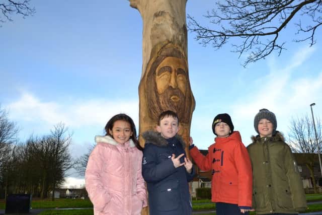 School friends, Sofi Mae Donnelly, Thomas Kerr, Cormac Mullan, and  Adam Sharkey enjoy a visit to the new tree sculpture near their school in Belmont.