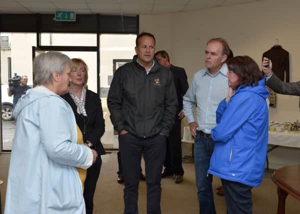 Taoiseach Leo Varadkar with Joe McHugh and local women in the Good to New parish charity shop, during their  flood inspection visit to Carndonagh. DER3417GS59