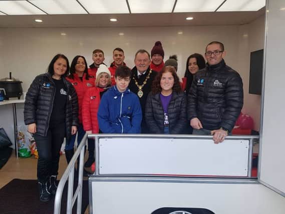 Tommy McCallion (left) with Mayor Maoliosa McHugh with group including Off The Streets representatives and young people at the new Mobile Hub.