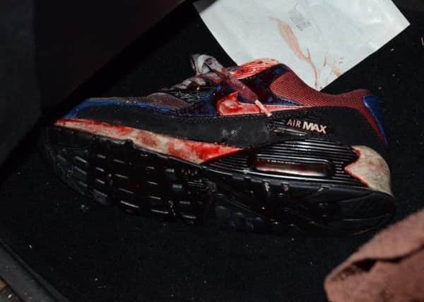 The bloodied trainer belonging to the shooting victim.