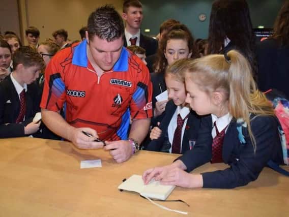 Daryl 'Suyperchin' Gurney signs autographs for pupils at Lisneal College.