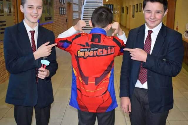 Zack McGarrigle sporting his new Superchin shirt as Jason Canning and Dylan Boyd look on.