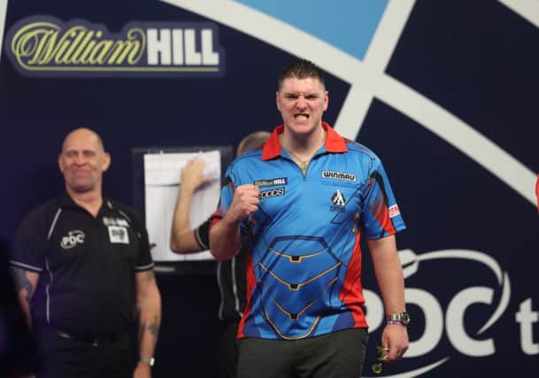 Daryl Gurney celebrates his first round victory over Ronny Huybrechts at the Alexandra Palace in London.