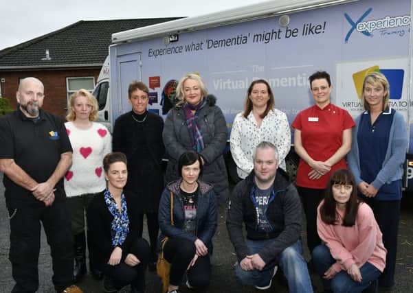 Jerry Rickett, left, of The Virtural Dementia Experience bus, pictured with Greenhaw Lodge staff and family members who took part in training, from left, back row, Wendy O'Hagan, Ronagh McCaul, Elaine McFeely, Leigh Chada, Caroline Deeney and Ruth McKeown, front row, Catherine McCaul, Georgina Doran, Lee Toland and Roisin McCarron. DER5117-149KM