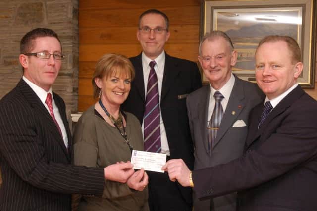 2007: Declan Curran, left, from City Maids 4 U, presents the North West People of the Year Awards with a sponsorship cheque, with all money raised going to the Foyle Hospice. Included, from left, Hannah Healy, homecare sister, Maurice Love, First Trust Bank, Dr Tom McGinley, Foyle Hospice director, and Martin McCrossan, North West People of the Year Awards chairperson. (0902PG53)