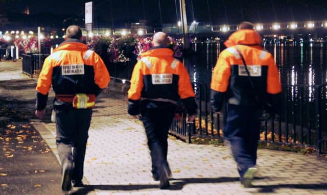 Volunteers from Foyle Search and Rescue patrolling along the river at night.