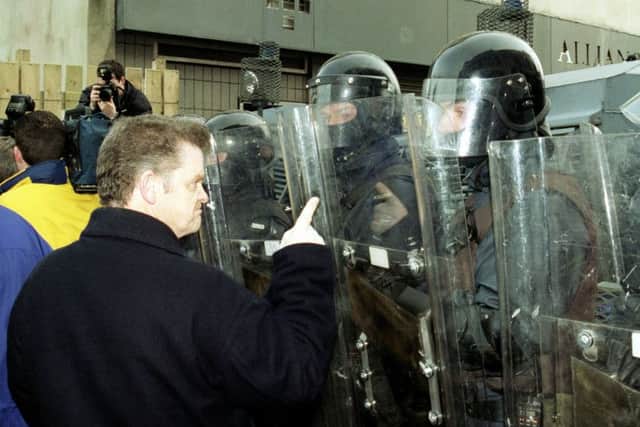 A protester facing down an RUC riot squad (Photo Hugh Gallagher