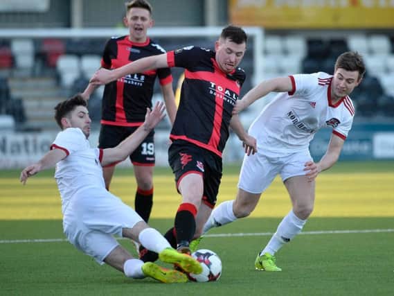 Crusaders Billy Joe Burns in action with Maiden City's James McClay.