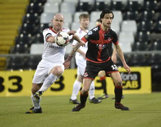 Crusaders' Declan Caddell in action with Maiden City's Darren McCready. Pic by Stephen Hamilton/Inpho