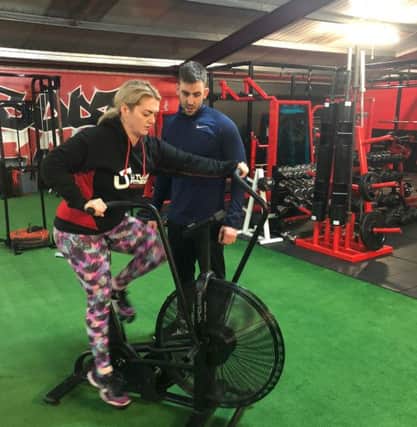 Aine is put through her paces on an assault bike by trainer Danny Glenn.
