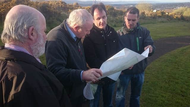 Sinn FÃ©in Councillor Christopher Jackson with late Sinn FÃ©in leader Martin McGuinness and Mark O' Doherty  and Joe McWilliams, board members of  Na Piarsaigh Doire Trasna GAC pictured previously looking at the plans for the new pitch.