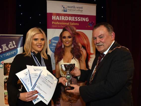 North West Regional College student Clara Arbuckle (left), who received first prize in the Themed Image Category, second place in Cut and Colour, and second place in Avant Garde at the college's Bohemian Hairshow. She is pictured with hair model Naomi McDaid and Cllr. Maolosa McHugh, Mayor of Derry City and Strabane District Council. (pic by Martin McKeown).