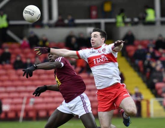Derry's Niall Toner contests this ball with Westmeath player Boidu Sayeh at Celtic Park on Sunday. DER0518-109KM