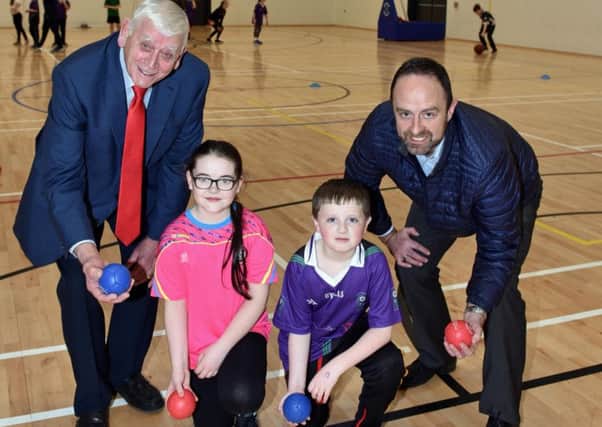 Alderman William King from Causeway Coast and Glens Borough Council and Willie Devlin from Sport NI pictured with Cara from Gaelscoil Neachtain and Oisin from St Canice's Primary School at the official opening of Dungiven Sports Centre.