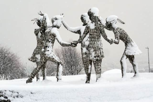 The snow clad Celebrate sculpture by Maurice Harron in the Creggan estate yesterday (Picture: Hugh Gallagher)