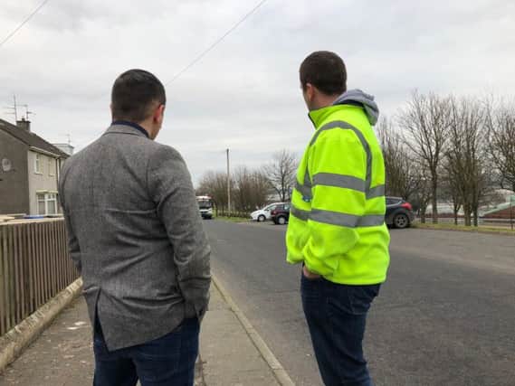 Colr Kelly and Transport NI staff inspecting the roadway Eastway/ Demesne.
