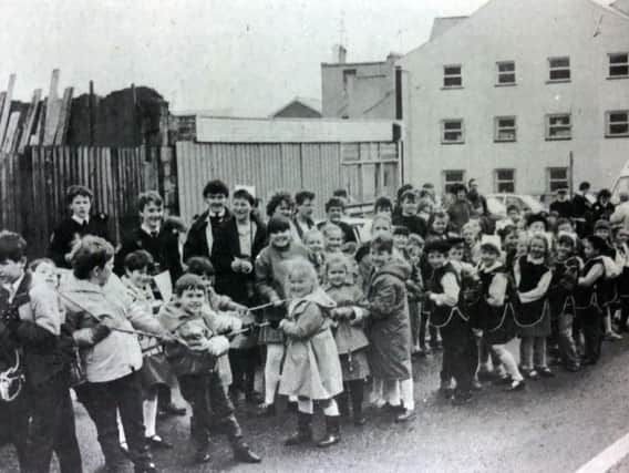 Local children take part in a bus-pull around Derry to raise money for charity in 1989.