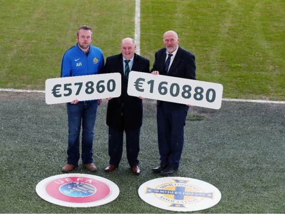 Aaron Hampton, Ardstraw Chairman, pictured with Irish FA Deputy President Jack Grundie and Bill Anderson, Institute Chairman.