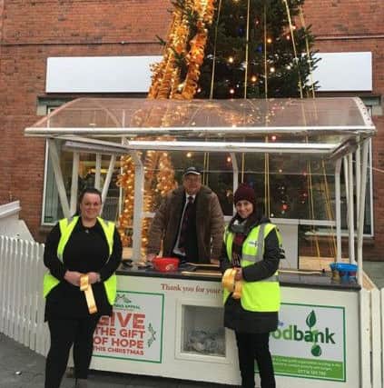 Local volunteers managing the Rotary Club's Memory Tree at Foyleside in the run up to Christmas.