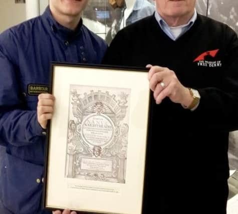John Kelly, on right, and Rossa ODochartaigh, of the Museum of Free Derry, pictured with the gift sent to them by the Archbishop of Canterbury.