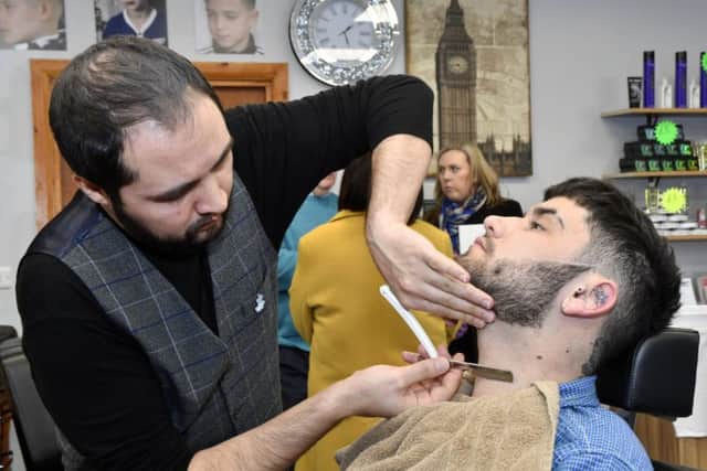 Shaun Cunningham has his beard trimmed by Merwan Aytas during the Men's Health Day event at the City Turkish Barbers, The Diamond, on Friday. DER1018-101KM