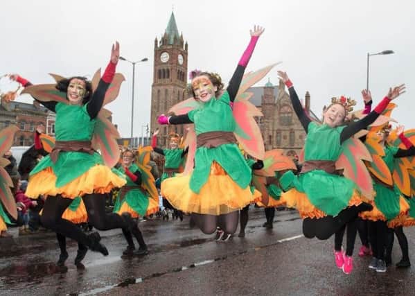 Dancers from St. Cecilia's College leap in the air as they make their way past the Guildhall during the annual Spring Carnival on St. Patricks Day in Derry last year. Picture Martin McKeown. Inpresspics.com. 17.03.17