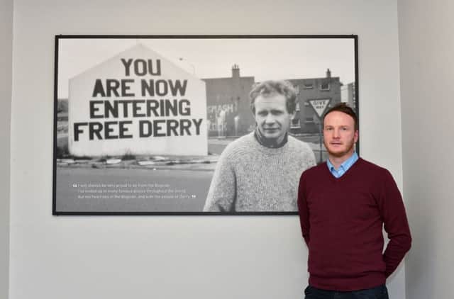 Fiachra McGuinness pictured beside a portrait of his late father, Martin. DER1118GS009