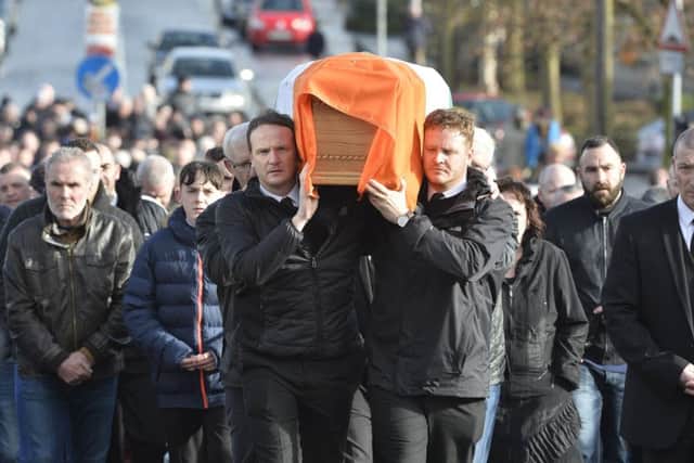 2017... Fiachra McGuinness and his younger brother, Emmett, carry their fathers coffin through the Bogside.